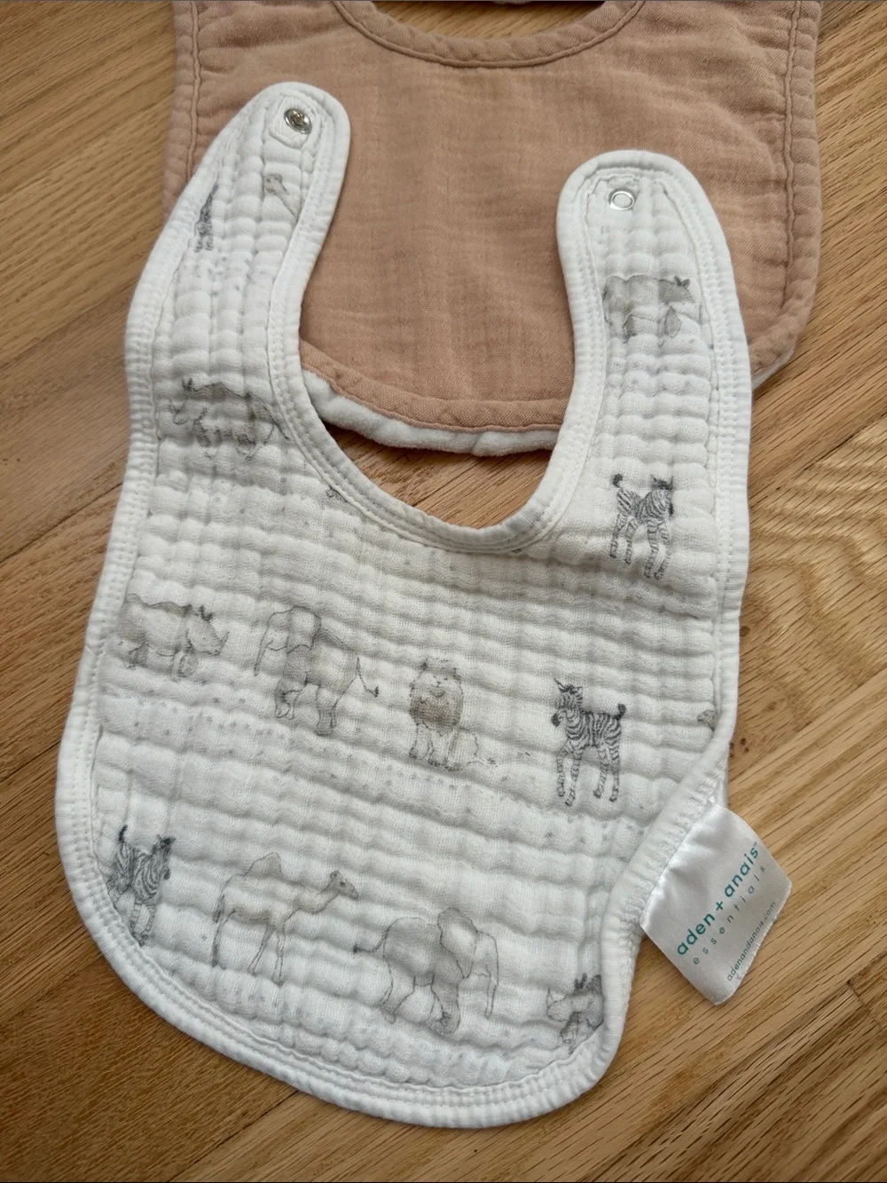 Bundle of muslin baby bibs in earthy colors